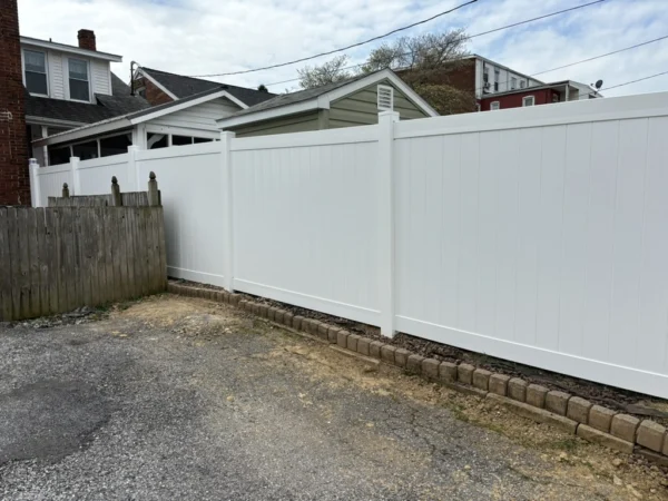 A&N Fencing is the #1 Harrisburg Fence Company. This image shows a sturdy fence on top of a rock wall.